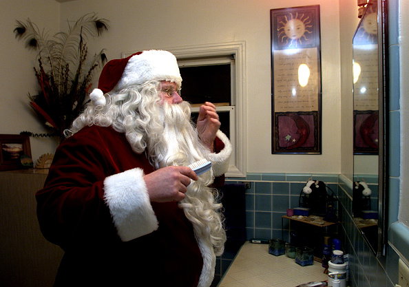Santa dressed Dan Long of Ventura readies to cheerup a group at a womens shelter in Ventura thursda