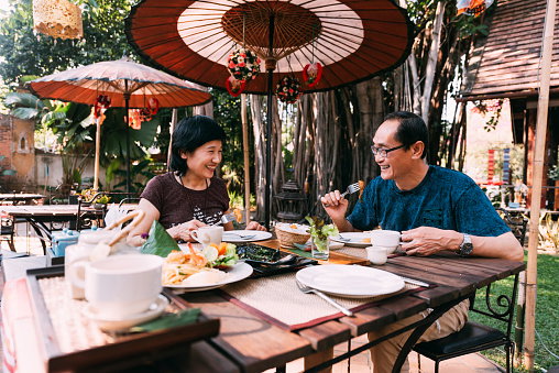 Mature couple enjoy lunch on their vacations in Southeast Asia