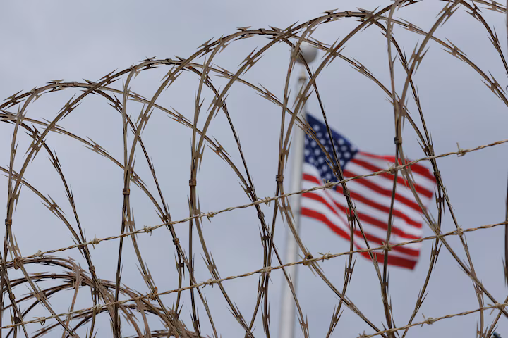 American flag seen through guantanamo bay fence
