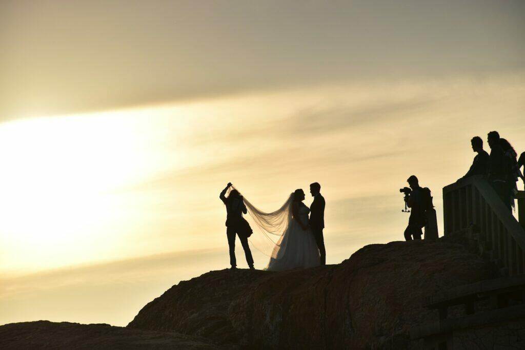 wedded couple on boulder