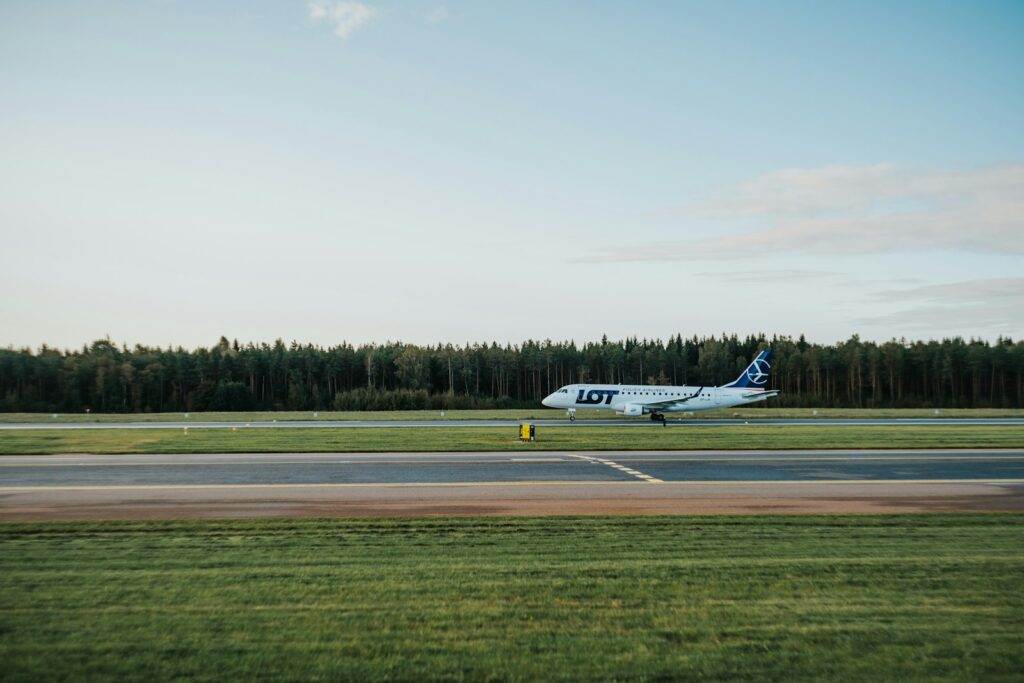 white plane near green grass field