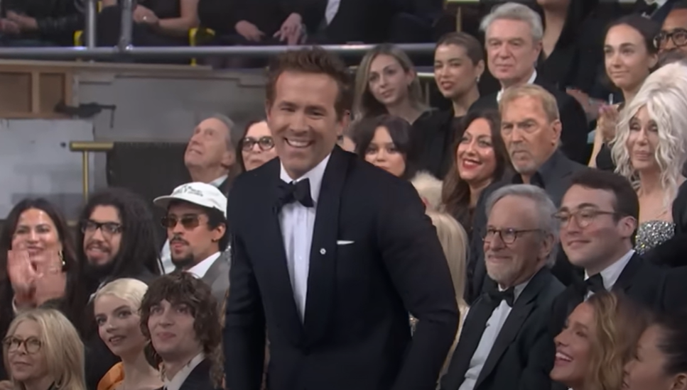 Ryan Reynolds smiling in the SNL 50th anniversary audience (YouTube | SNL)