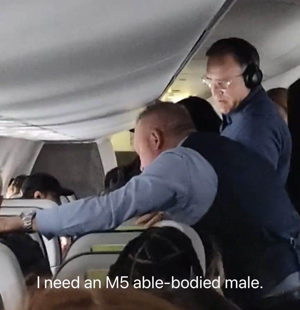 An Alaska Airlines flight attendant punches an unruly passenger in the throat and torso to force him to let go of a woman’s hair.