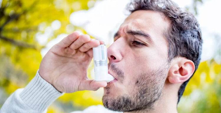 Guy using inhaler