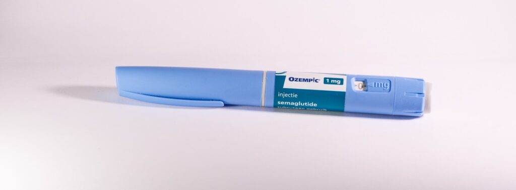 A blue pen sitting on top of a white table
