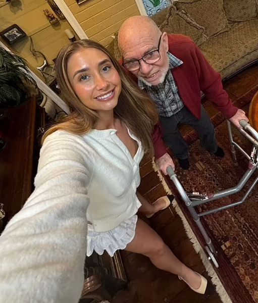 Lily Phillips and old man taking a selfie.