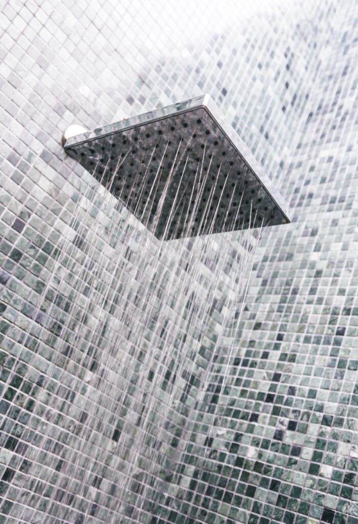 Head shower with water drop in bathroom interior