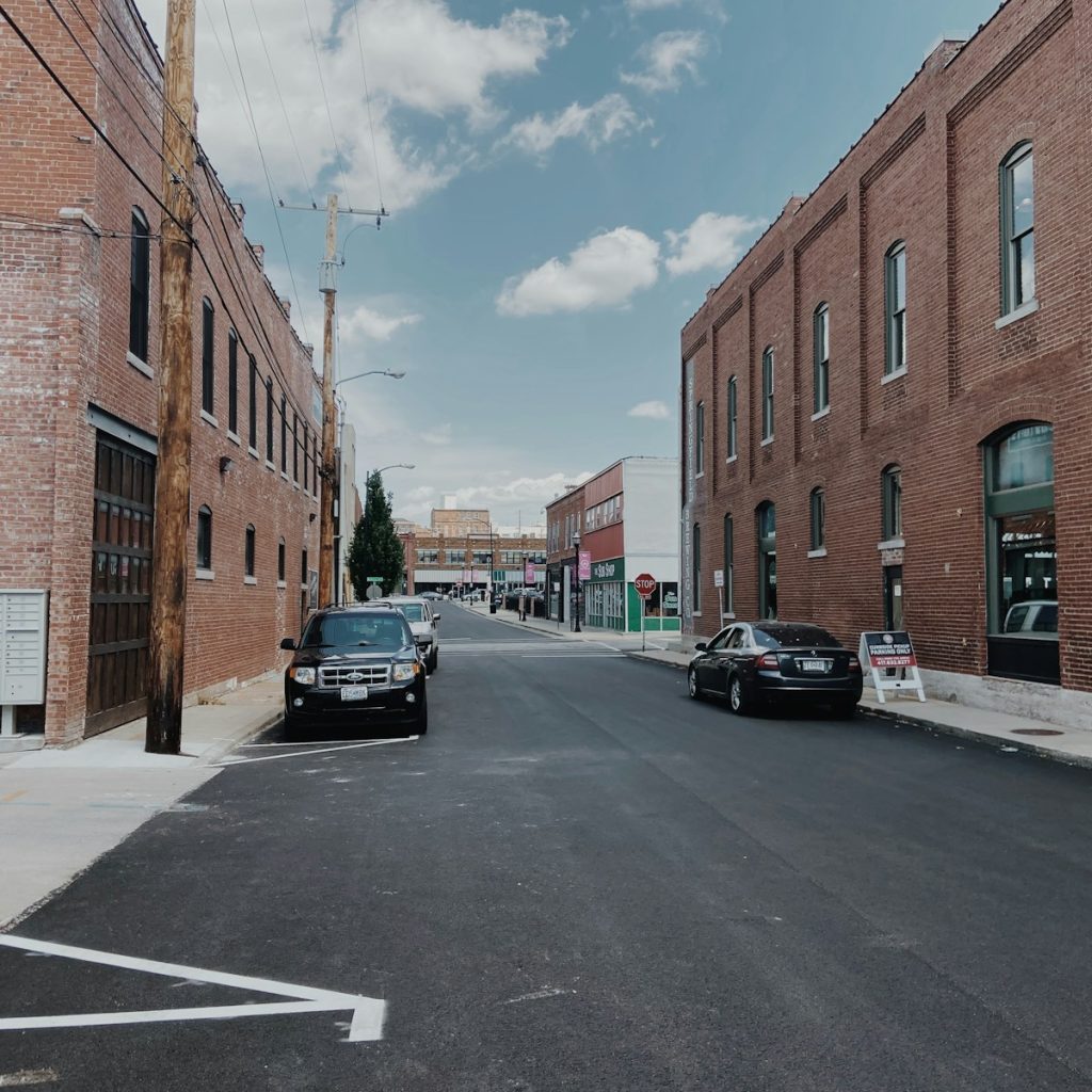 cars parked in front of brown building during daytime