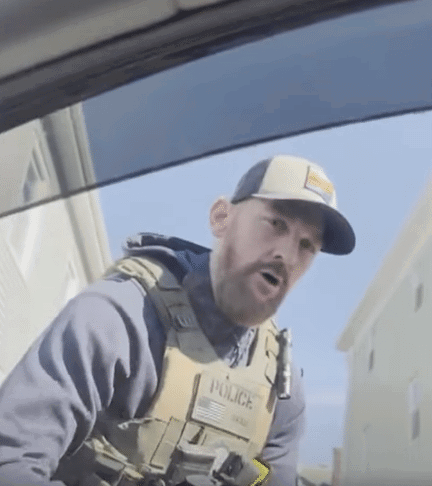 ICE agent detaining man in car