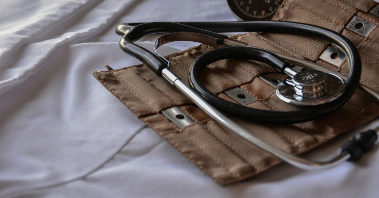 Black stethoscope with brown leather case