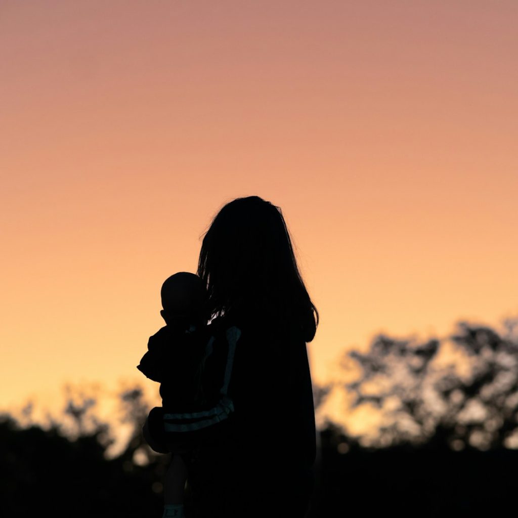 silhouette of a person and child
