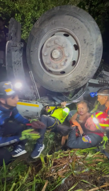 Rescuers saving baby girl from crash in Thailand (Thairath TV / AP)