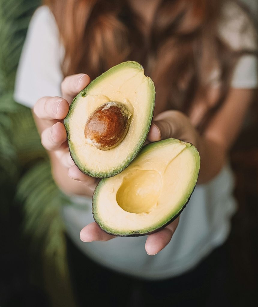 Woman holding avocado