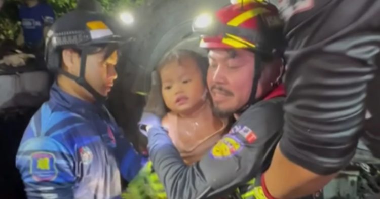 Rescuers saving baby girl from crash in Thailand (Thairath TV / AP)
