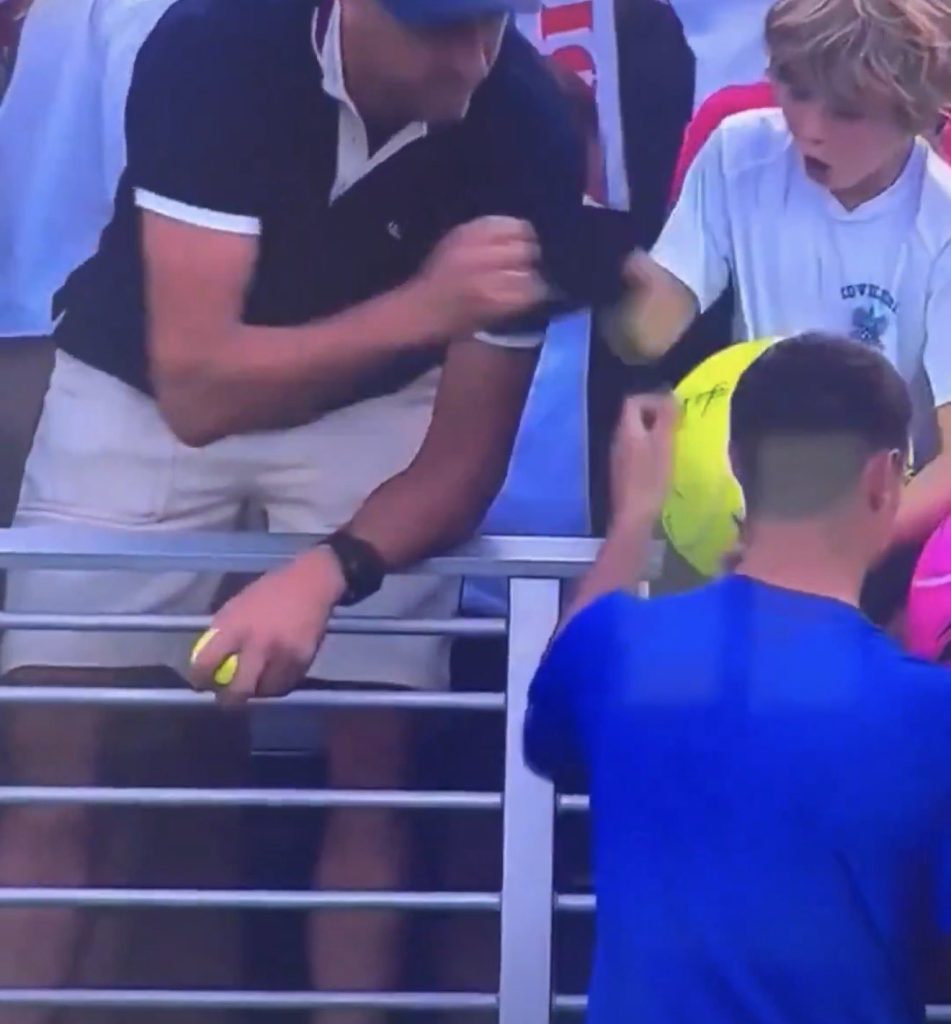 CEO taking hat from child at US Open