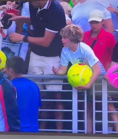 CEO taking hat from child at US Open