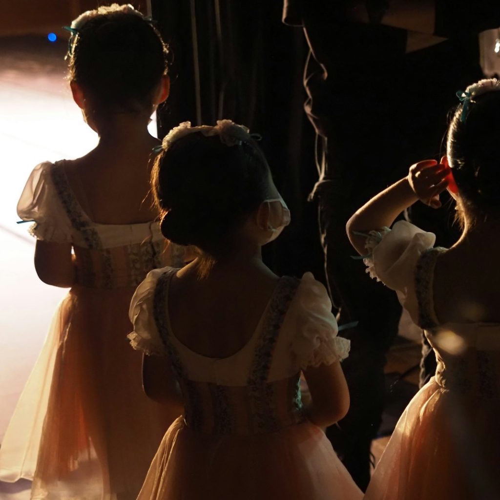 a group of little girls standing next to each other