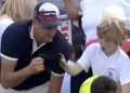CEO taking hat from child at US Open