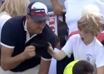 CEO taking hat from child at US Open