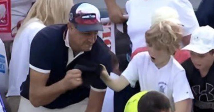CEO taking hat from child at US Open