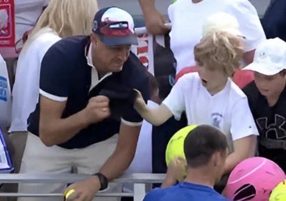 CEO taking hat from child at US Open