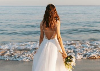 Woman in wedding dress on the beach