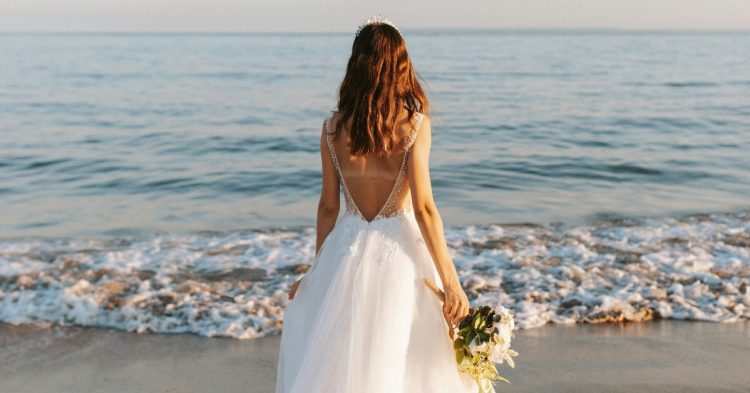 Woman in wedding dress on the beach