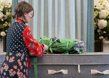 Woman standing by casket
