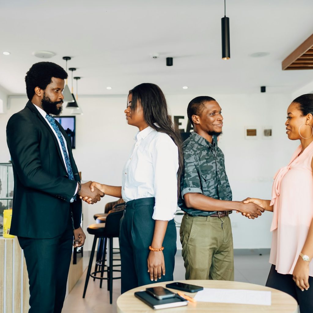 A group of people shaking hands in a room