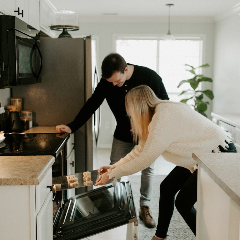 man and woman by open range oven