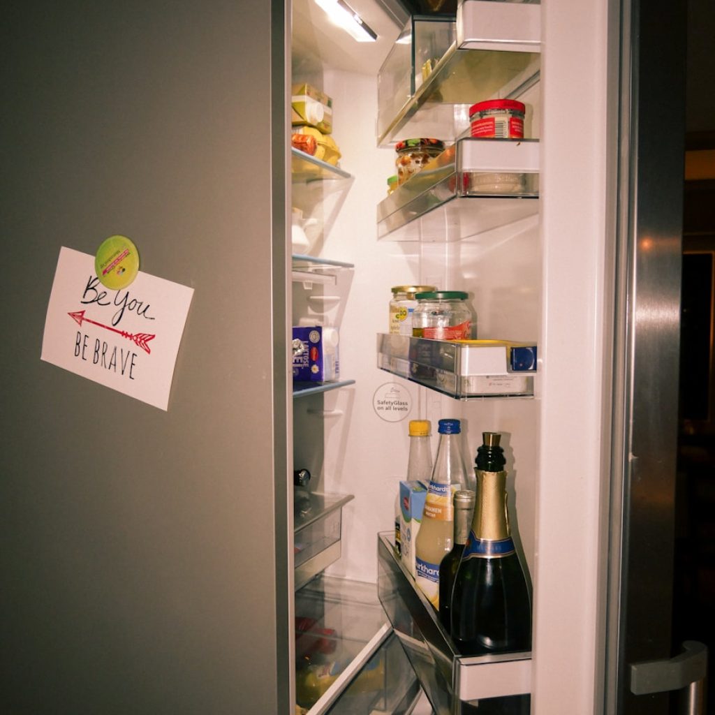 A refrigerator with its door open and food in it
