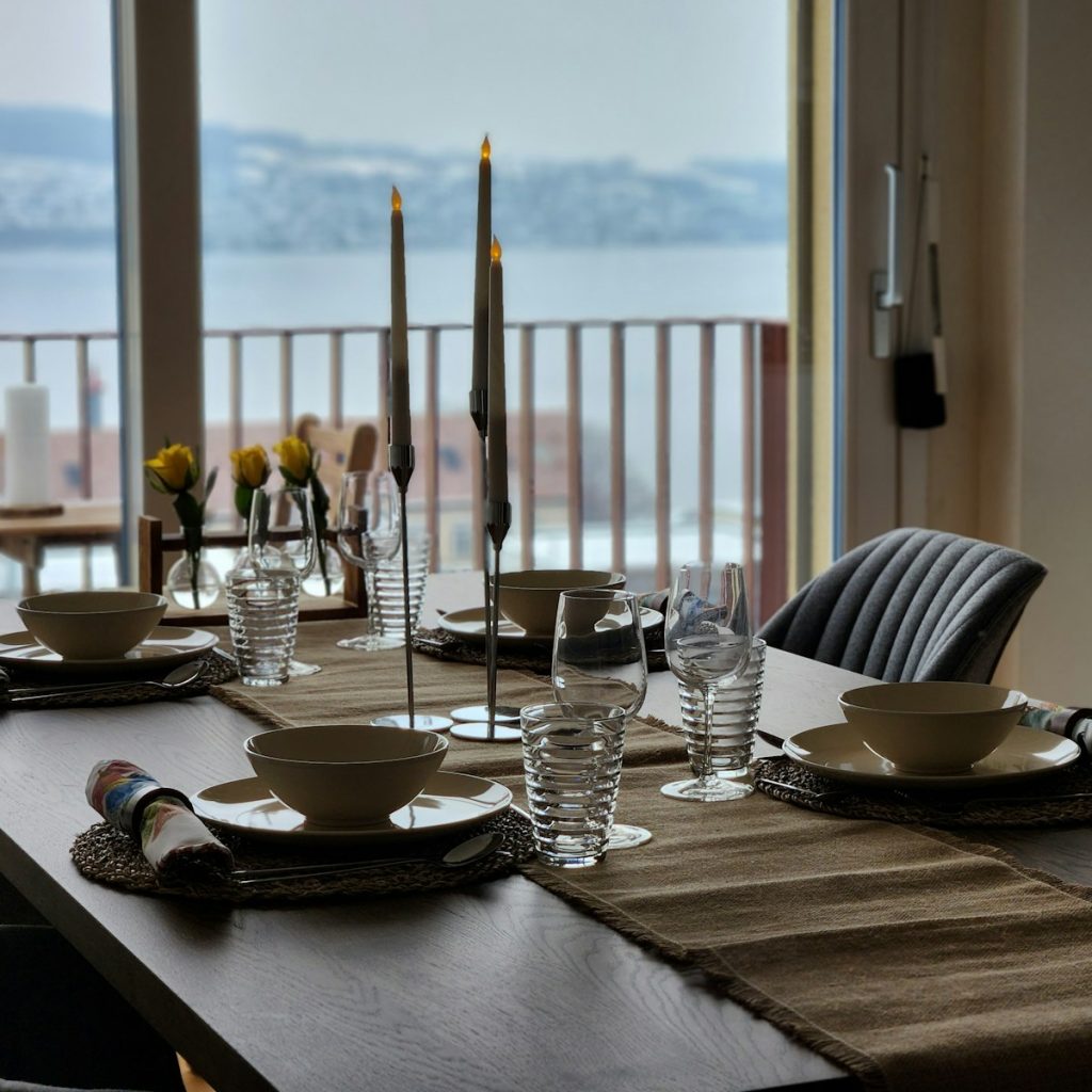 a dining table with place settings and place settings