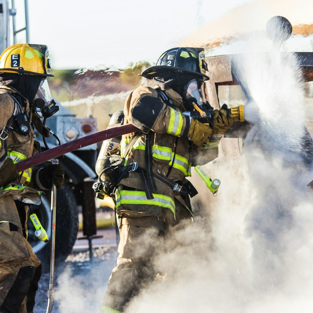 three fireman preventing fire during daytime
