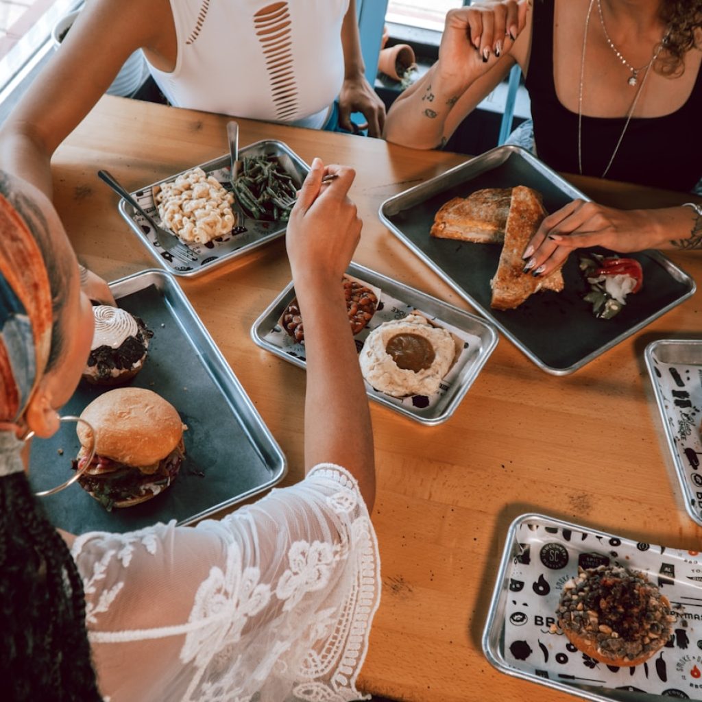 a group of people sitting around a table eating food