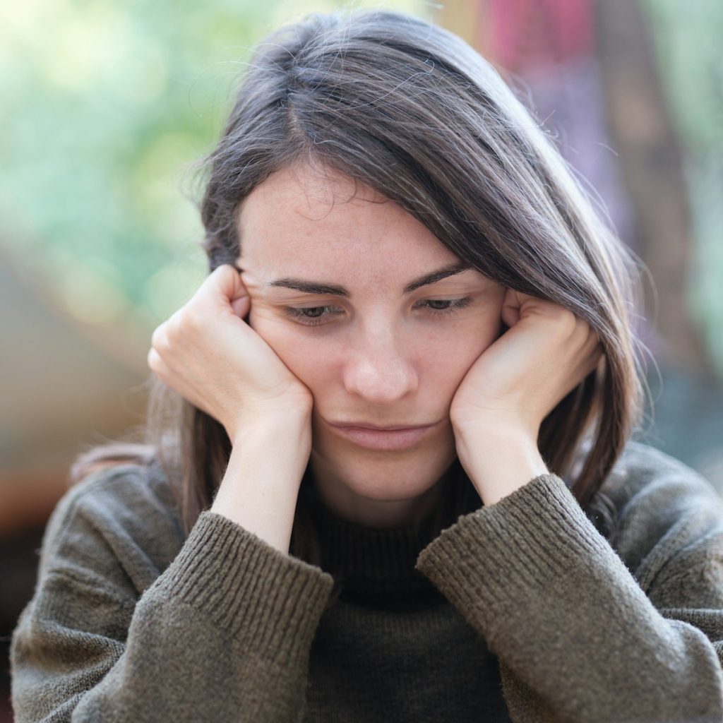 a woman holding her head in her hands