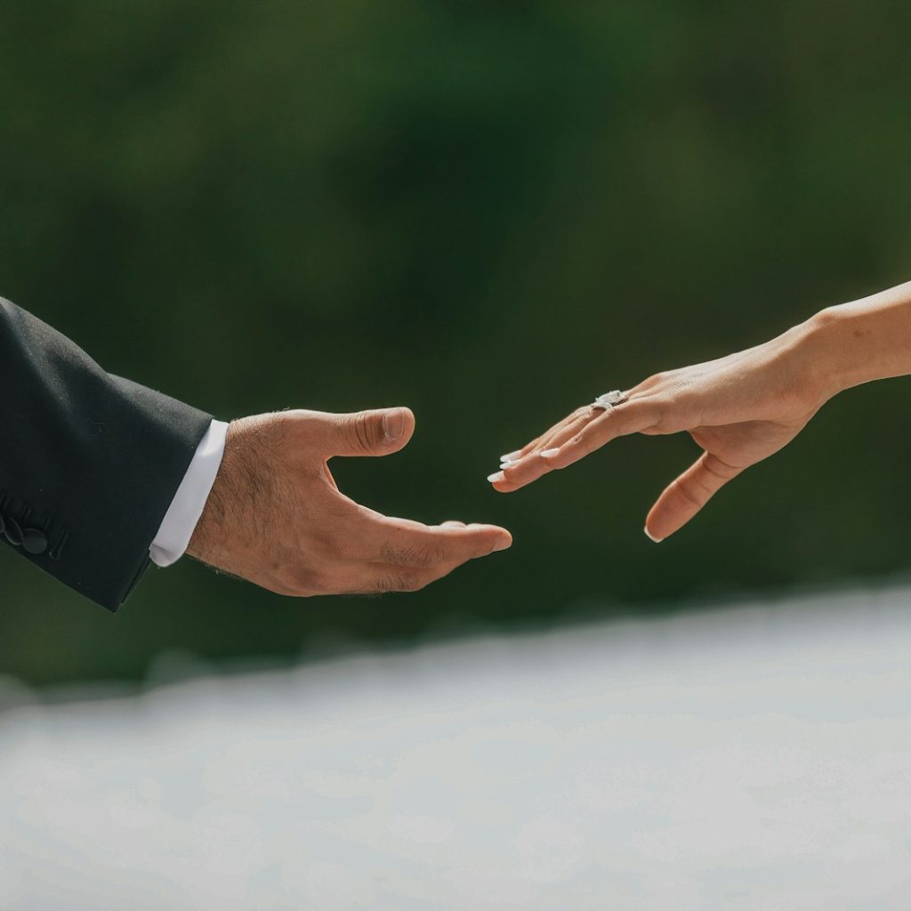 A close up of two people holding hands
