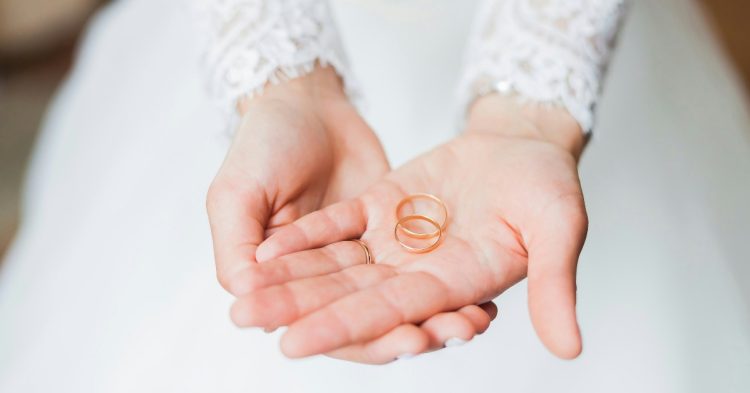 Bride holding wedding band