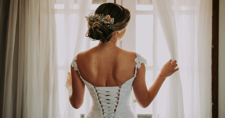Bride looking out window