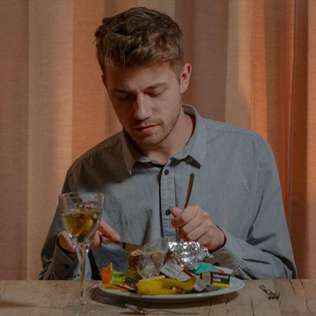 man in gray dress shirt sitting on chair