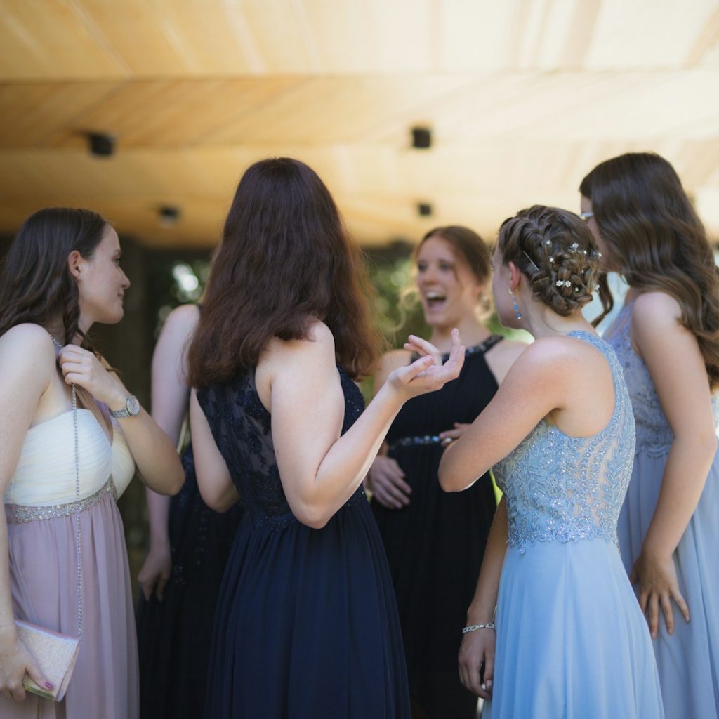 woman in black dress standing in front of woman in white dress