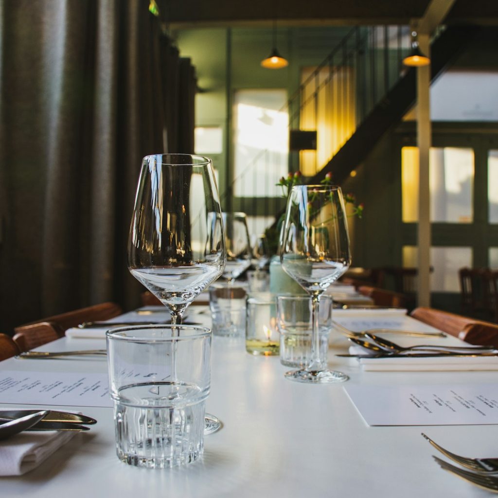 clear wine glasses on top of dining table
